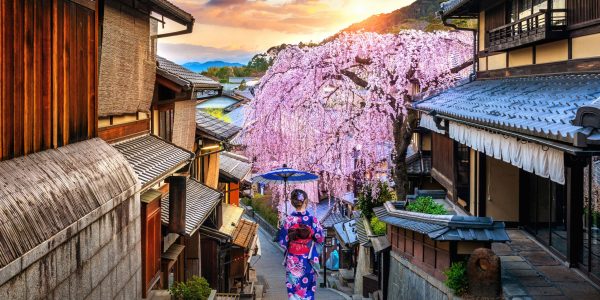 Woman wearing japanese traditional kimono walking at Historic Higashiyama district in spring, Kyoto in Japan.