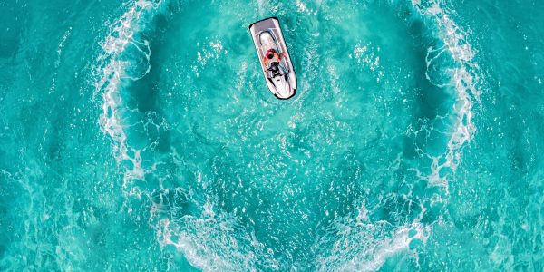 Jet Ski splash love heart symbol. Aerial view clear turquoise Maldives tropical sea